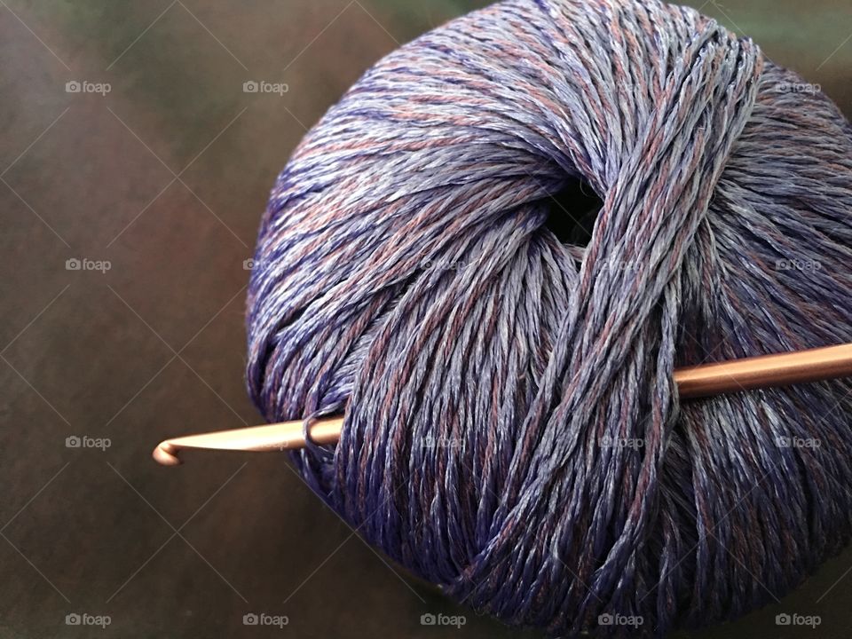 Close up yarn ball with crochet hooks