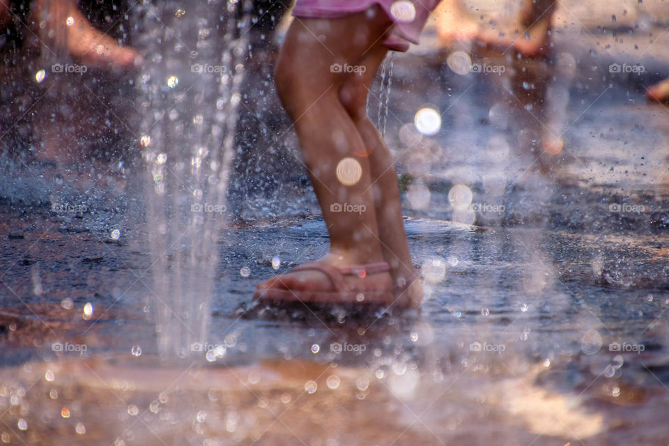 Cute little feet in a splash pad