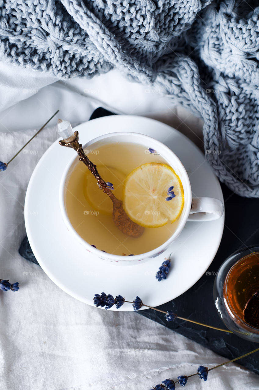 Warm cup of tea with lemon and honey on a bad
