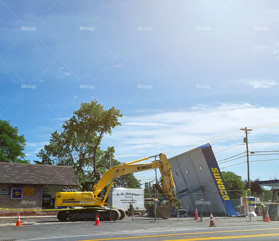 Excavator taking down a Sunoco canopy