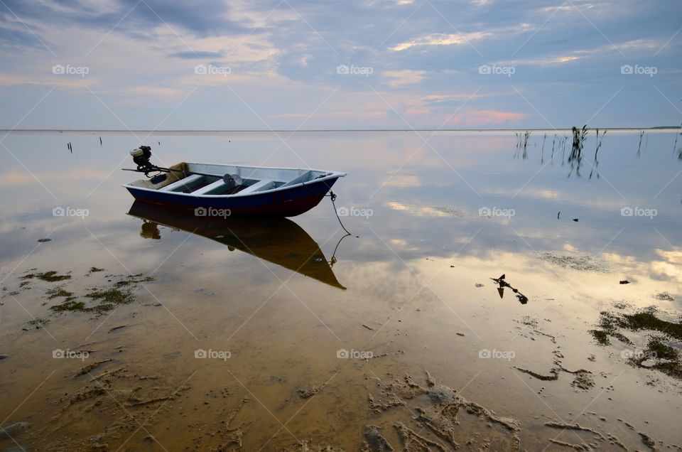 beautiful beach with fisherman boat during sunrise at Jubakar Beach Kelantan, malaysia.