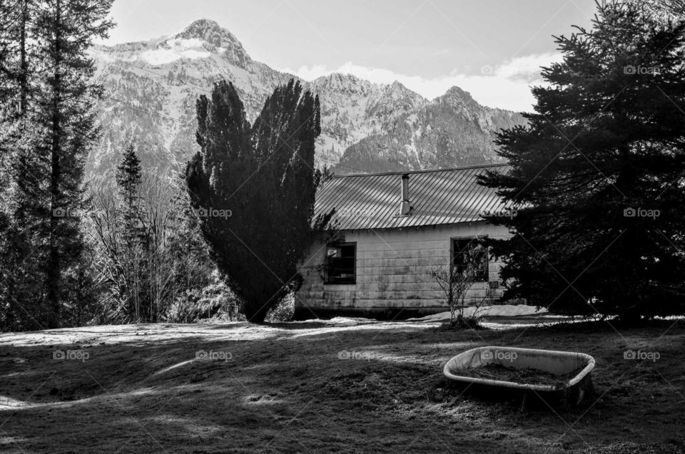 vintage mountain cabin with snowcapped mountain background