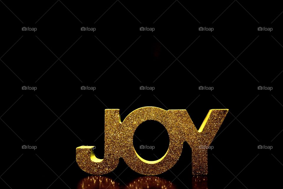 The word Joy in display against a black background. Happy New Year Celebration, 2016