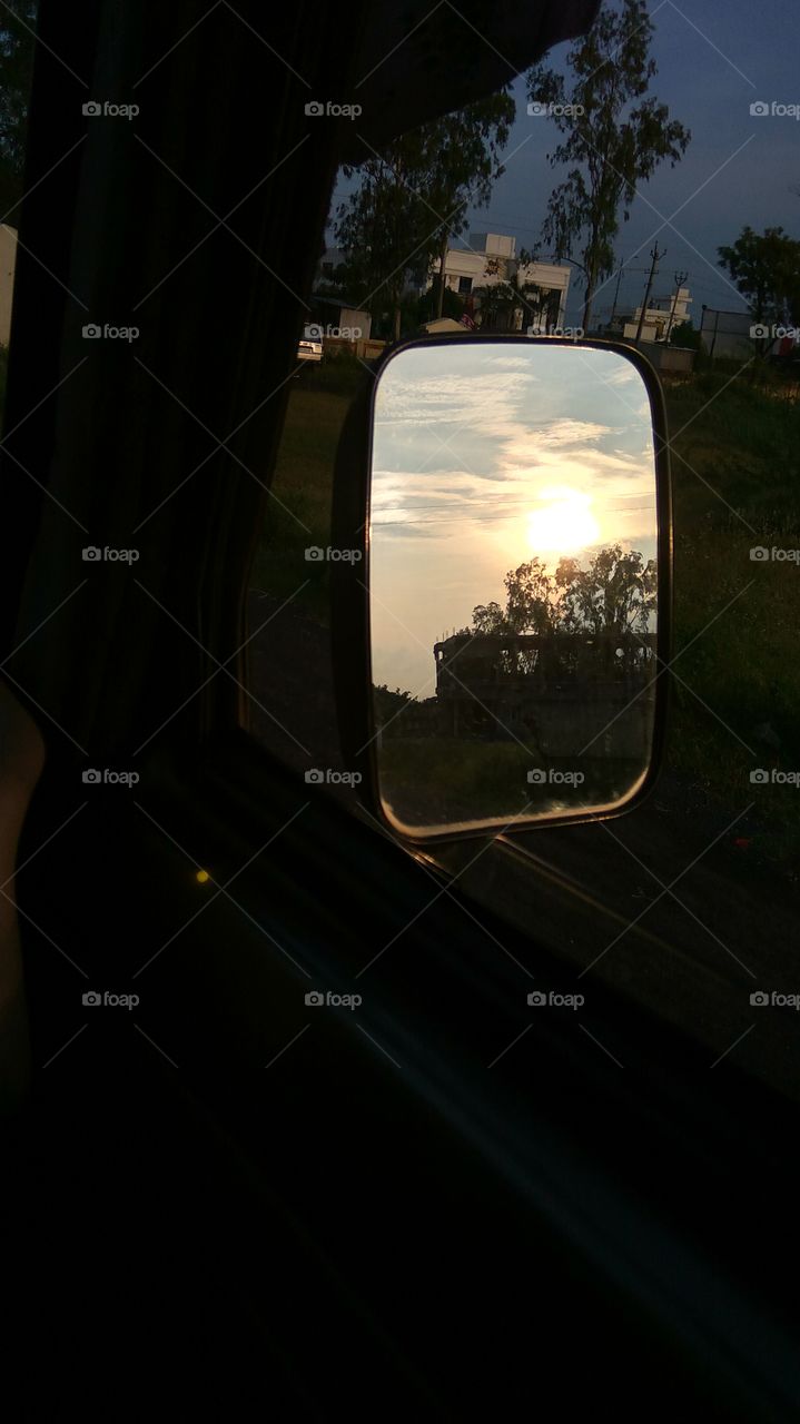 car side mirror sunset viewing