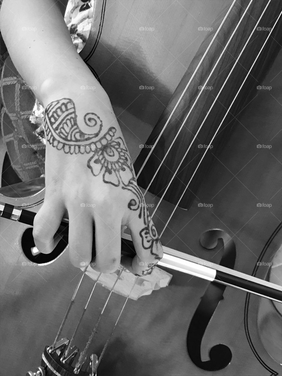 The beauty of music: my amazing pre-teen daughter was practicing her cello for an audition today and the beauty of her hand with the flowery details of henna tattoo set against the slick, smooth lines of the bow and body of the cello struck me as needing to be photographed and shared. Enjoy!