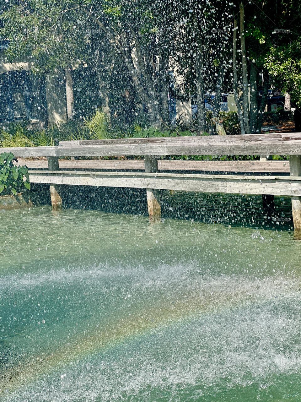 Sunlight through the spray of a fountain in a city park. Everyday beauty outdoors.