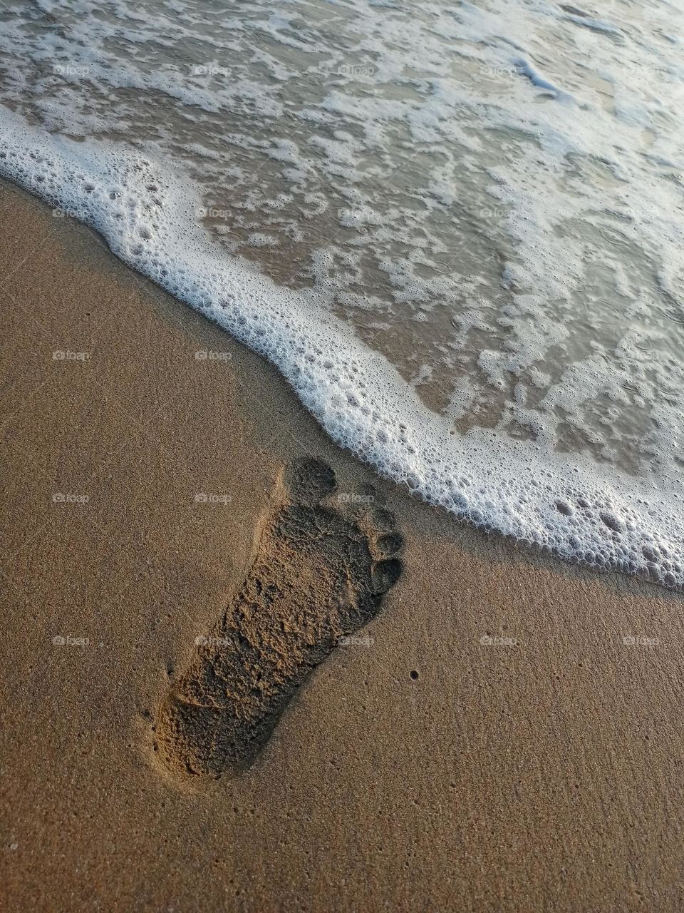 Hide and seek between human footprint and wave it's lucking beautiful