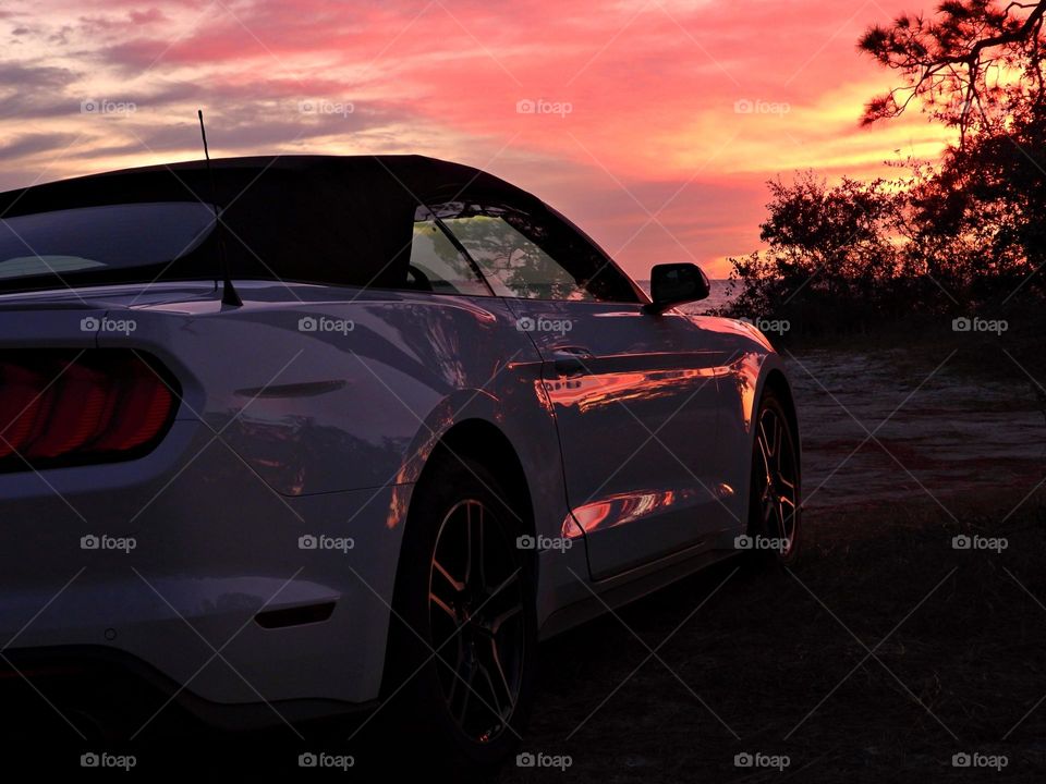 Sunset Reflection off the side of the car - 2021 Convertible Ford Mustang GT on the beach at sunset 