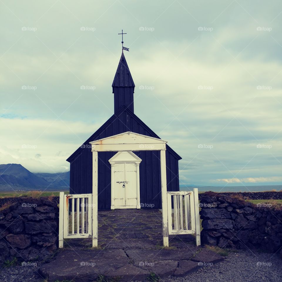 This Little Black Church sits adjacent to a lava field. It overlooks a black sand beach with huge chunks of black lava littering the hillside and the beach.