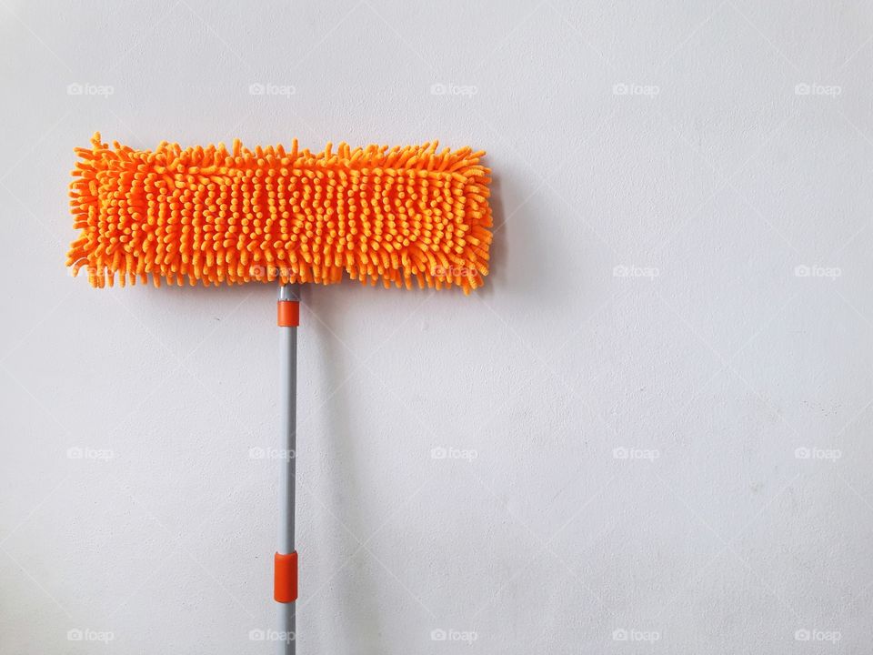orange mop with white wall
