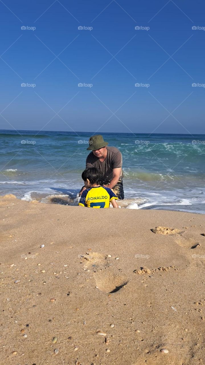 Picture of me playing with my little boy on the seashore. I was so amused