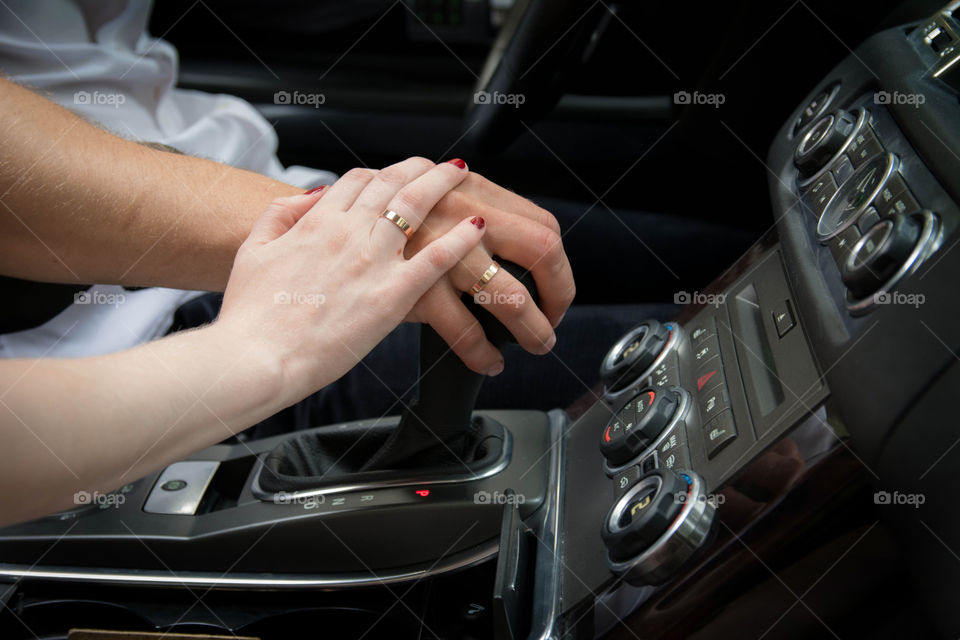 hands. just married in range rover sport