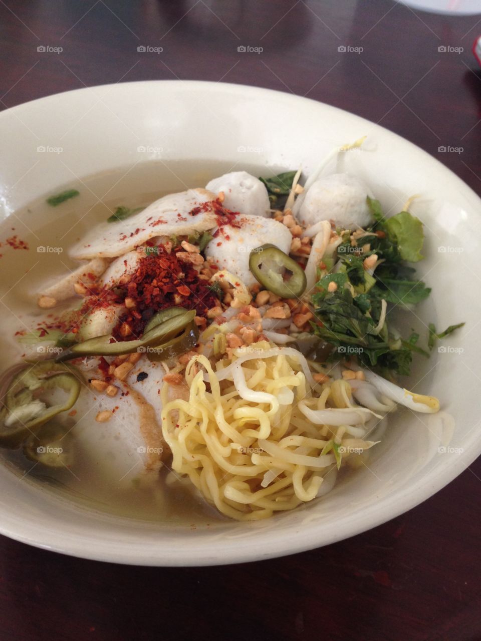 Thai Traditional noodle . Ba Mee Tom Yum is one of the most common dish in Thailand, on every corner of the street you can see people with the head down enjoying their noodle. The price of this delicious dish is around 40thb, 1.5 Usd