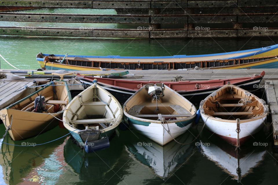 Line of rowboats docked 