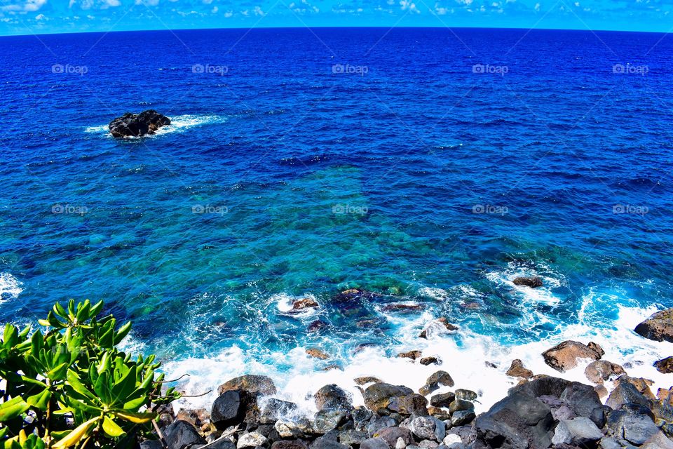 Beautiful clear blue water and blue skies on Hawaii island