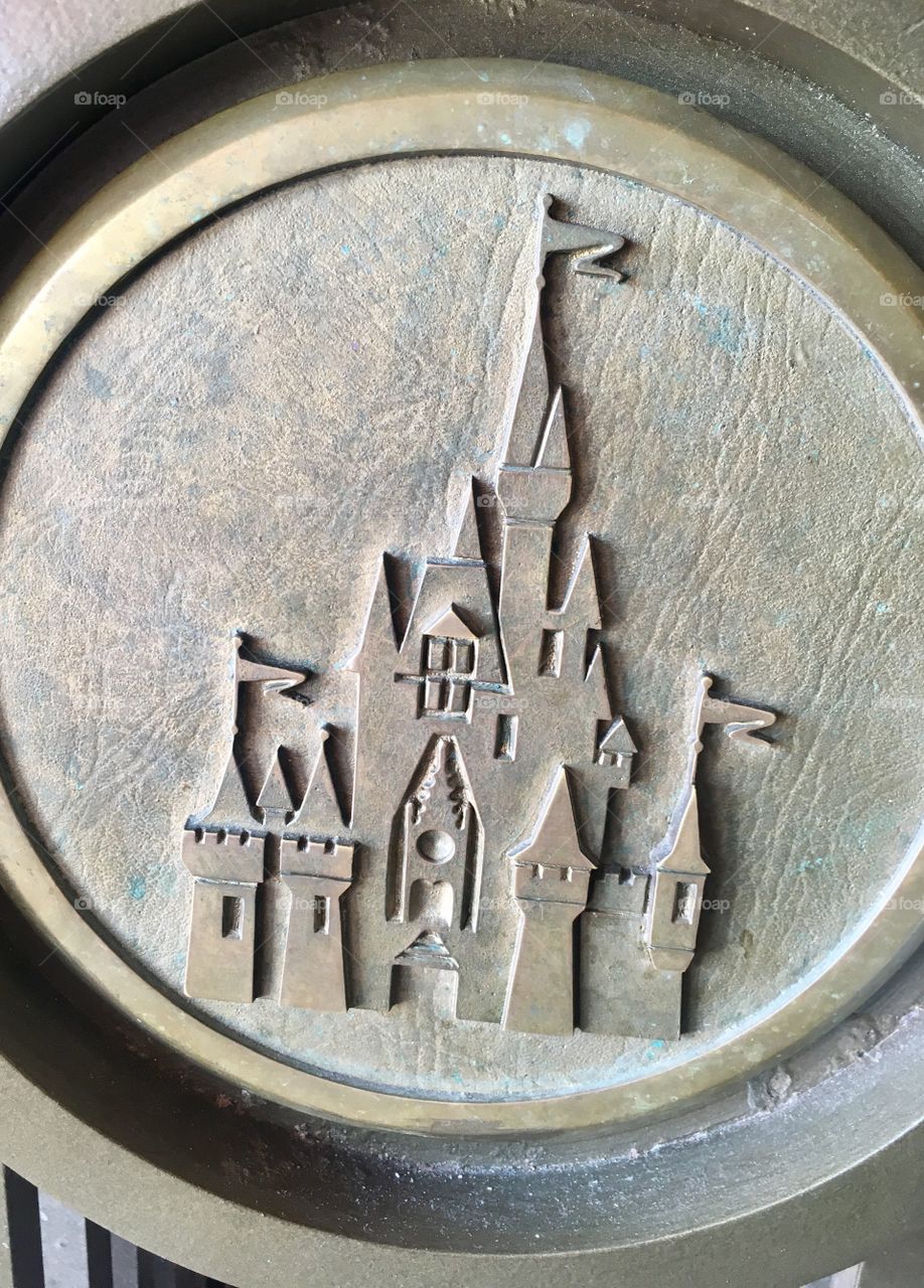 A piece of metal artwork in Disney World. An engraving of Cinderella’s Castle