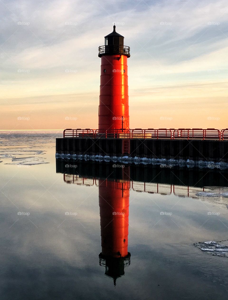 Lighthouse reflected on sea