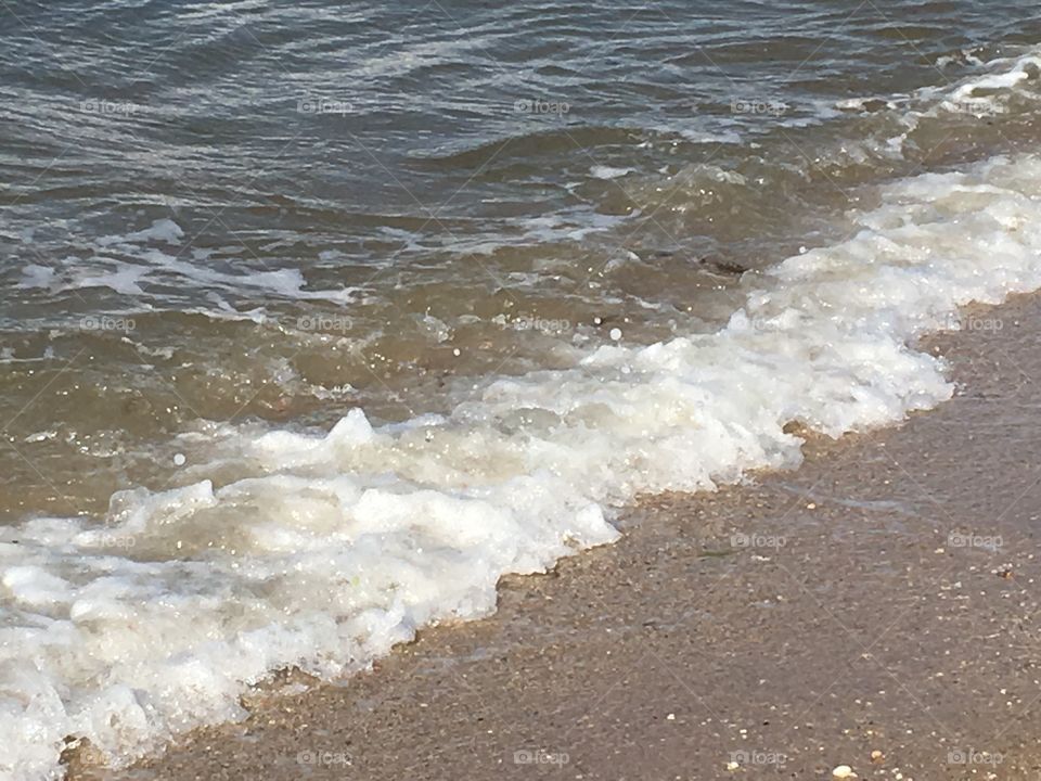 Ocean water waves on the beach.