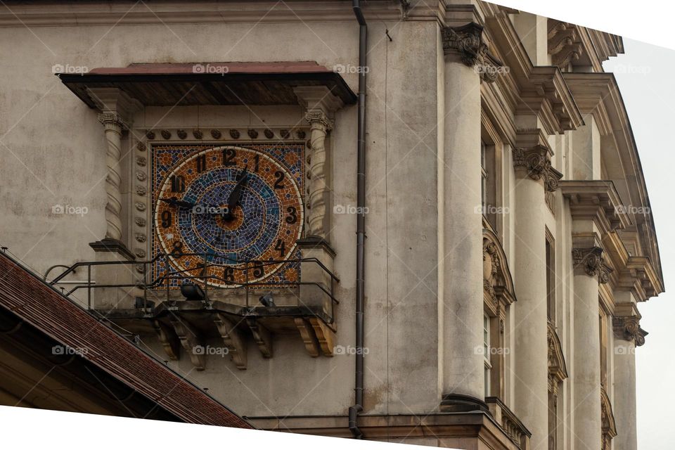 close-up of a beautiful clock on the facade of a tenement house in the old town of Poznan