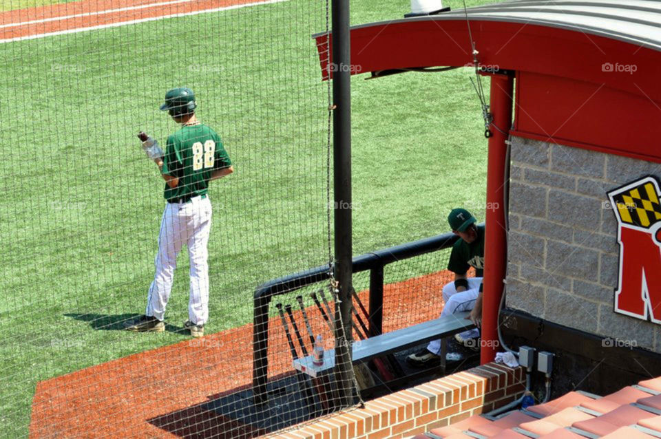 On deck!. 6 foot 8 batter waits on deck for his turn at bat at a university of Maryland baseball tournament