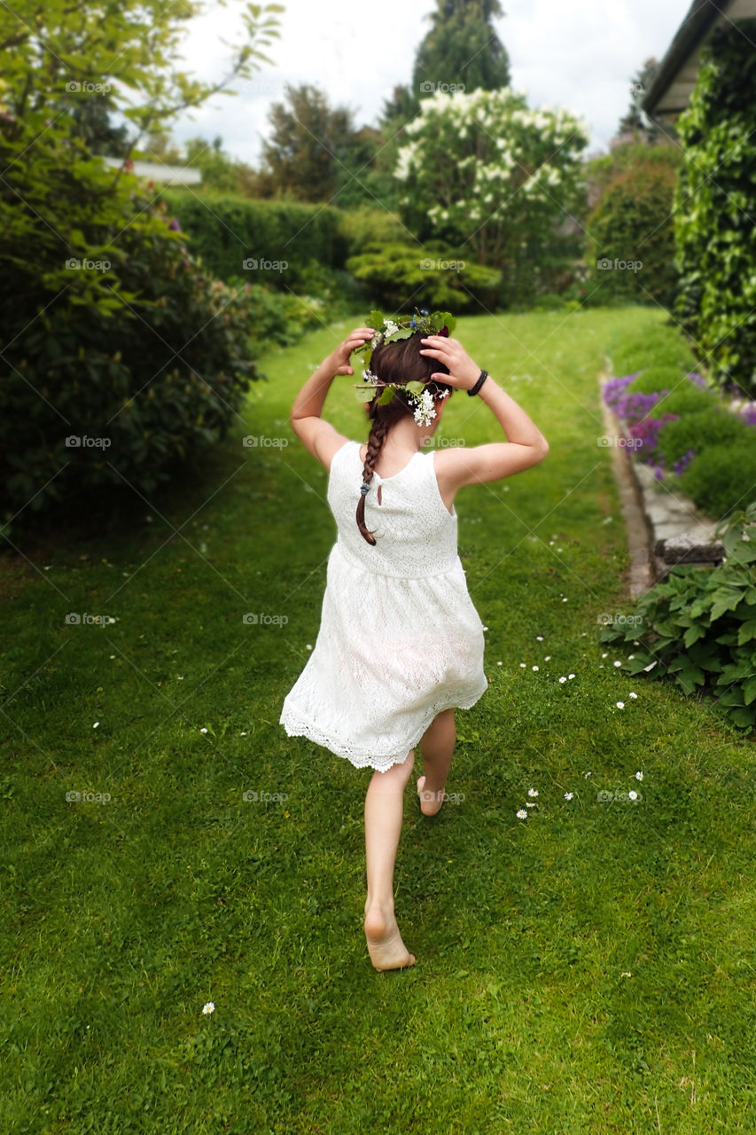 Girl running in garden