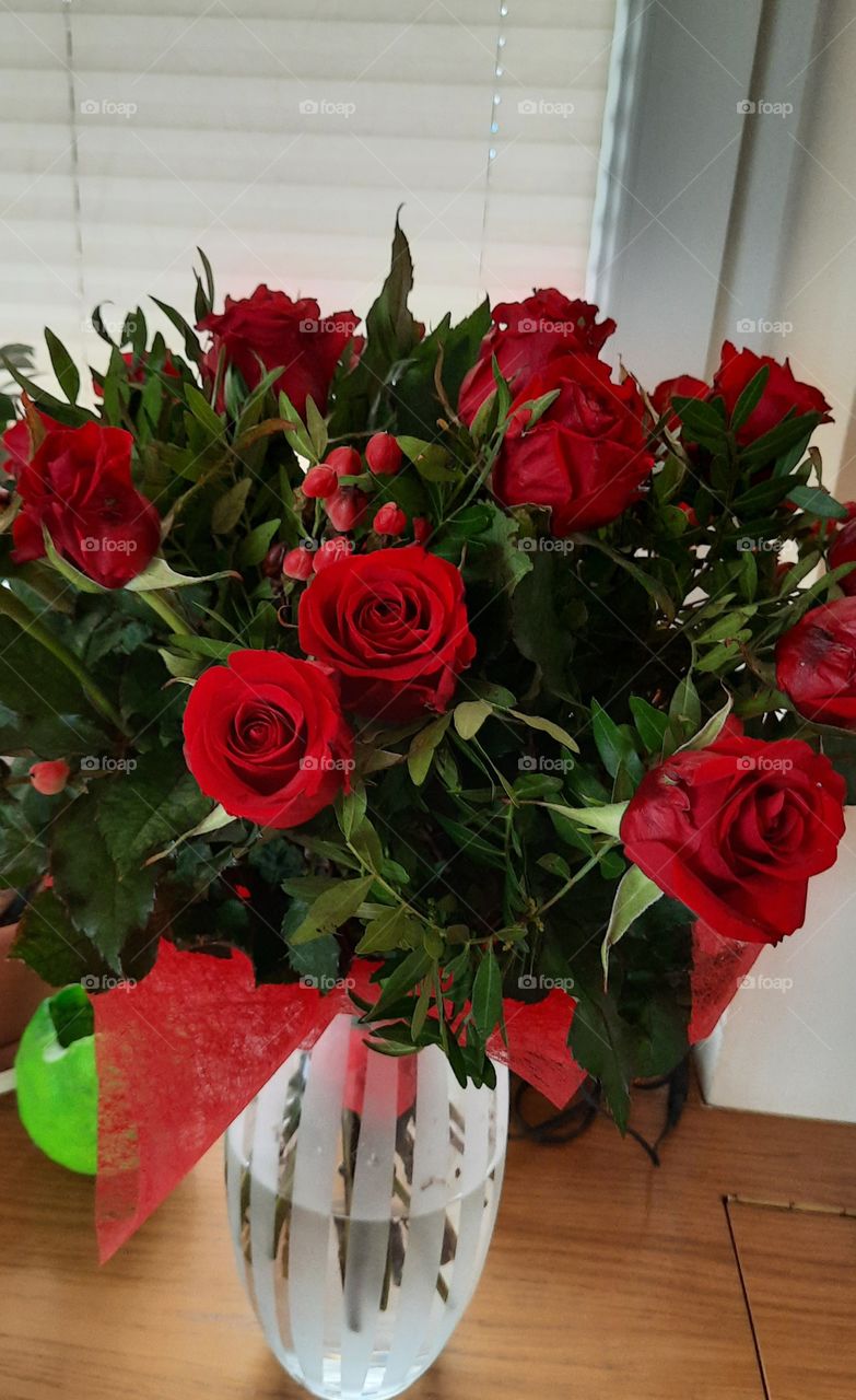 bouquet of red roses  in white glass vase