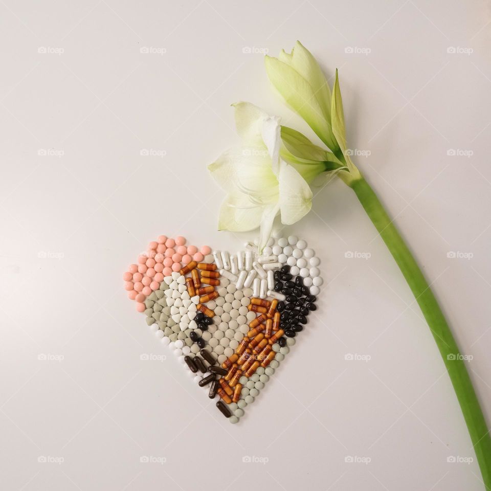 Pills heart with white flower