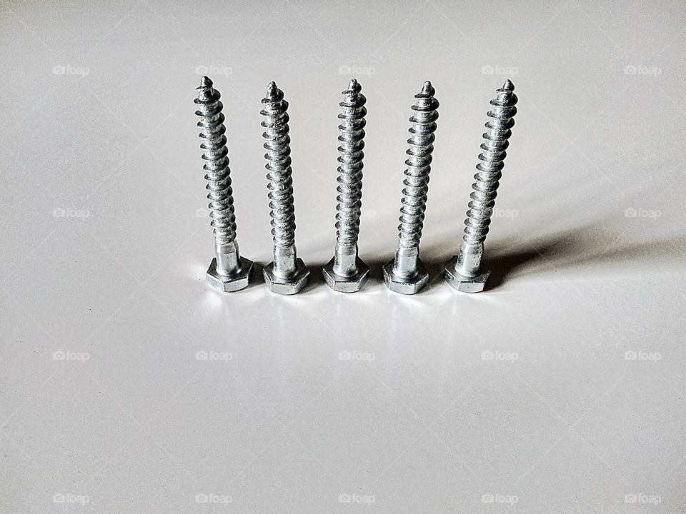 subject metal by foaр missions,metal screws on a white background