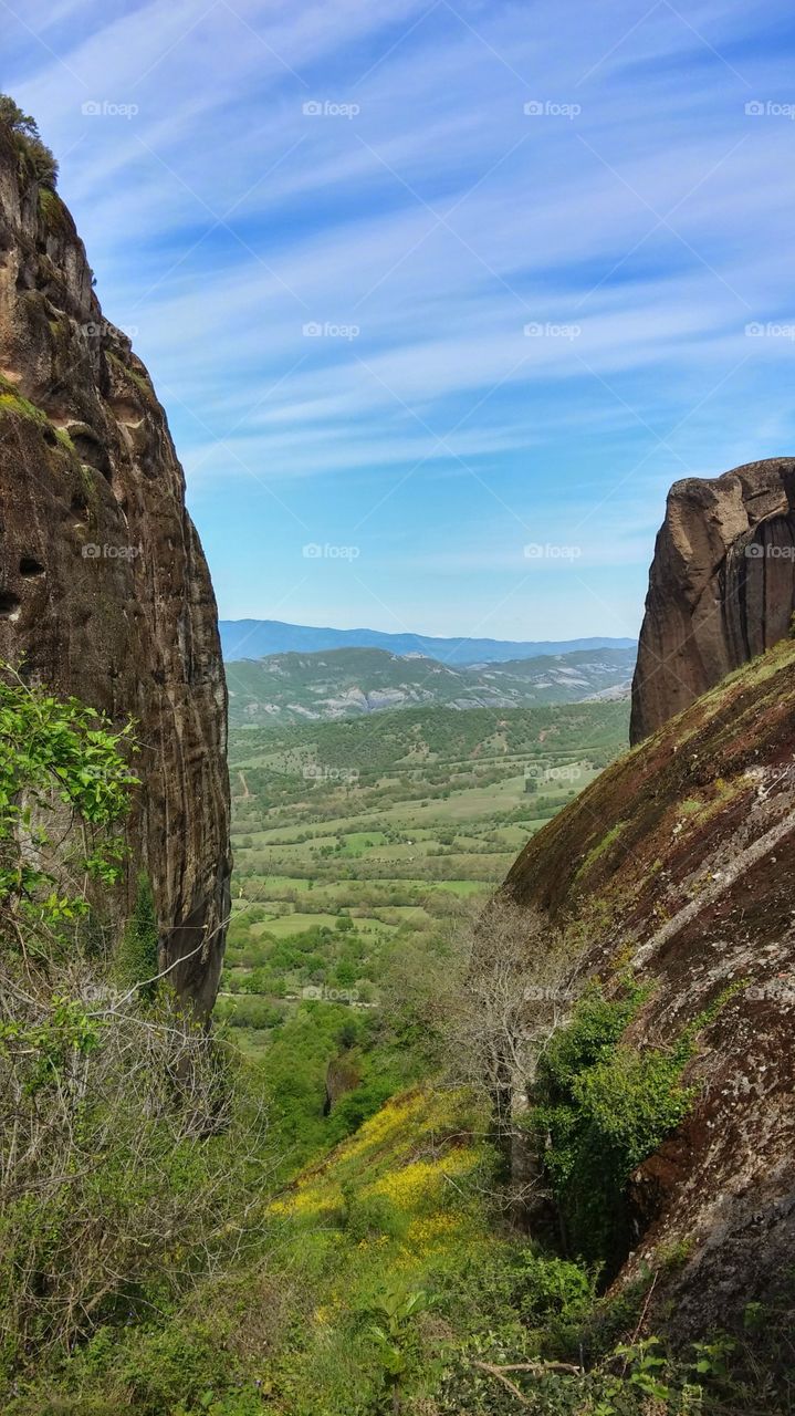 Scenic view of a grassy land against cloudy sky