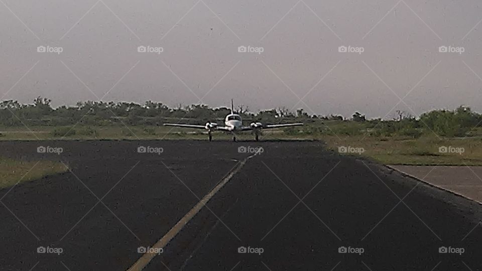 airport runway. this airplane is preparing for take off