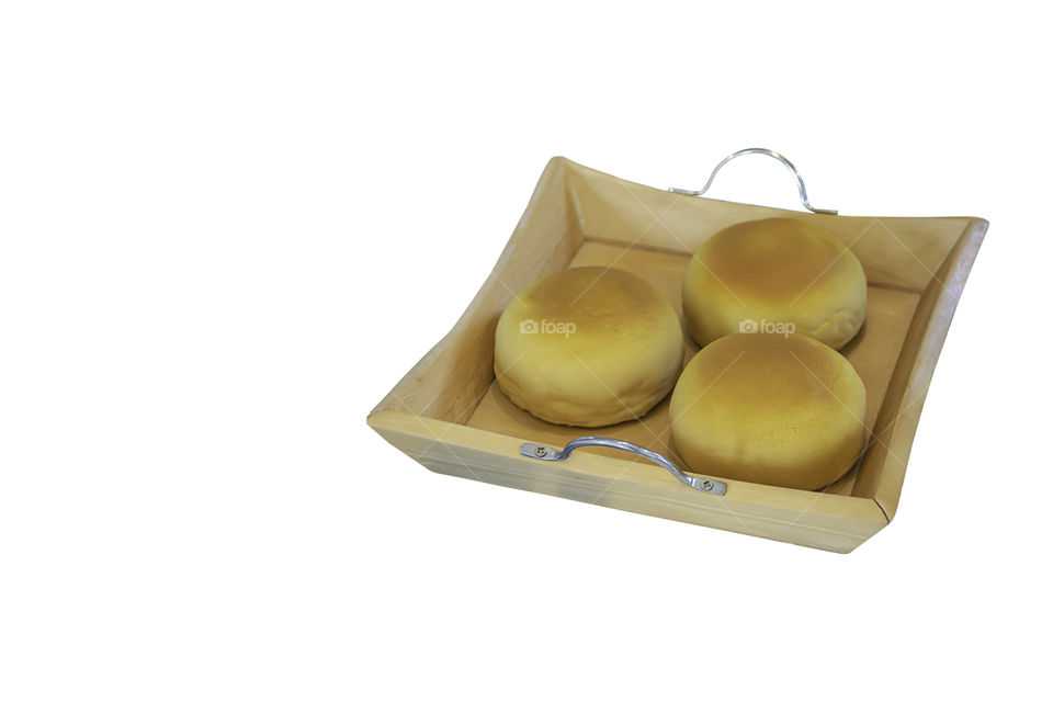 Isolated bread made from plastic in wood plate on a white background with clipping path.