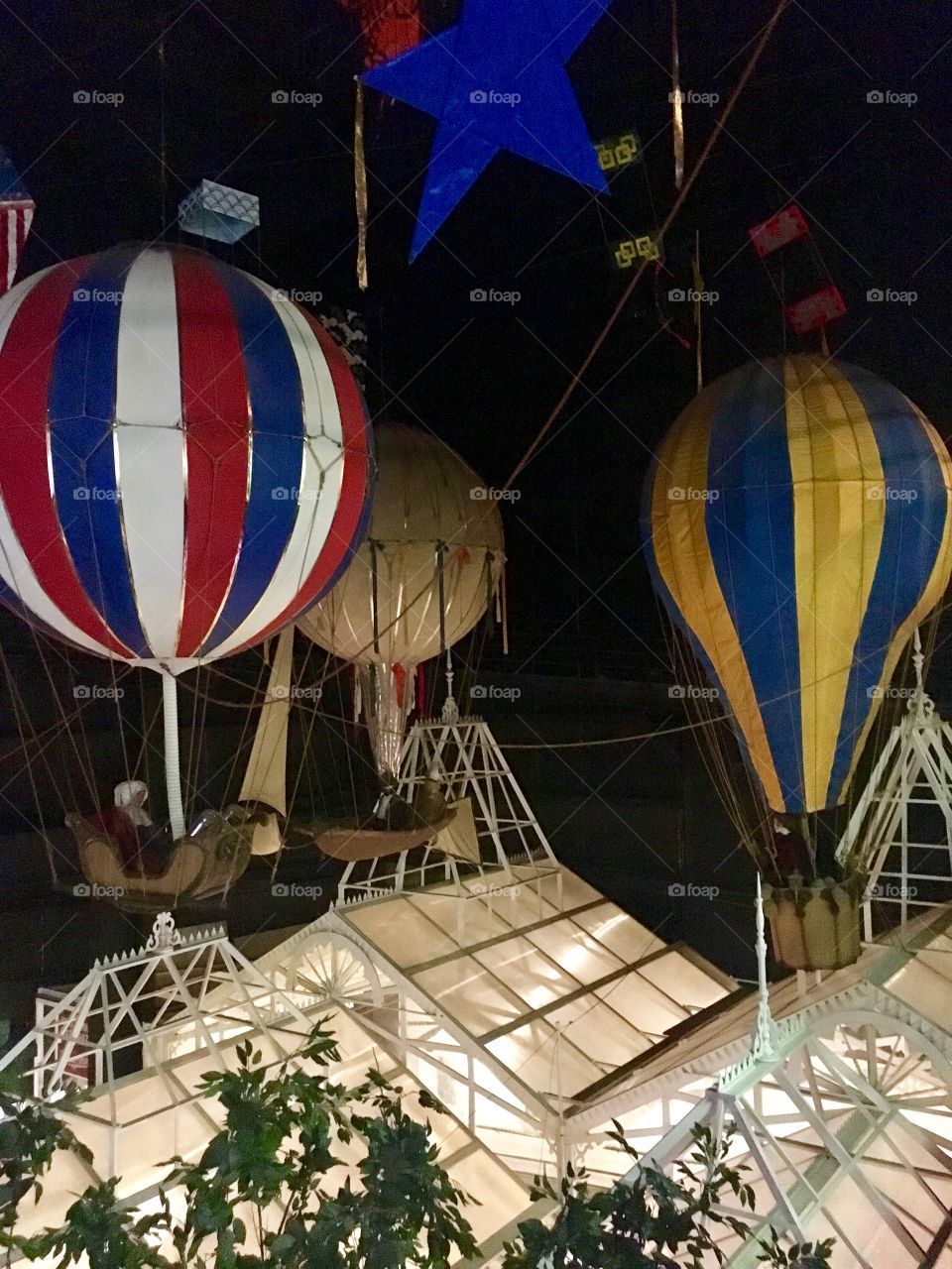 Vintage hot air balloons above green house style buildings. House on the Rock, WI