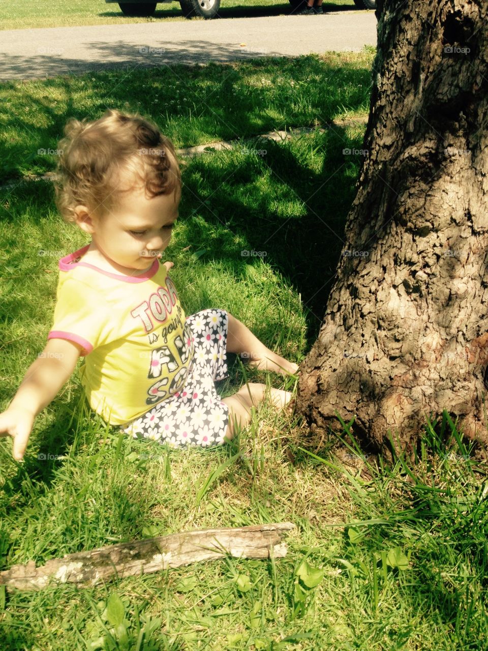 Toddler Sitting by Tree