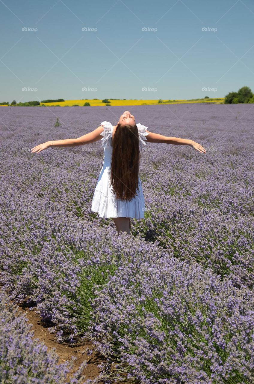 Woman with beautiful natural hair on lavender fields