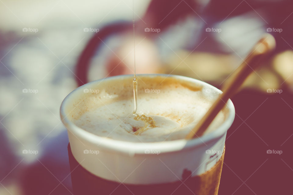 Starbucks Coffee with Pouring Honey into Foam