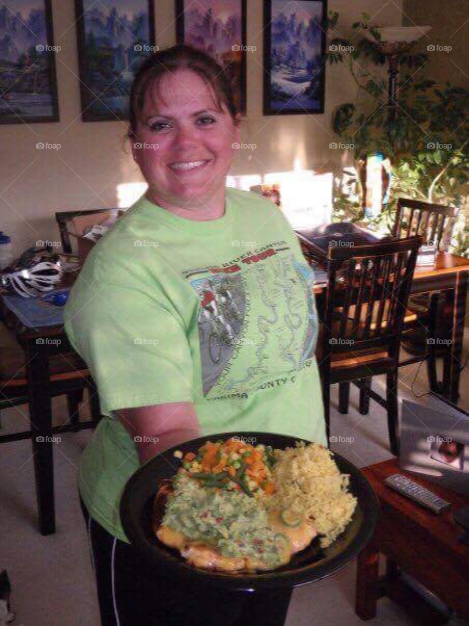 Smiling woman holding delicious food in plate