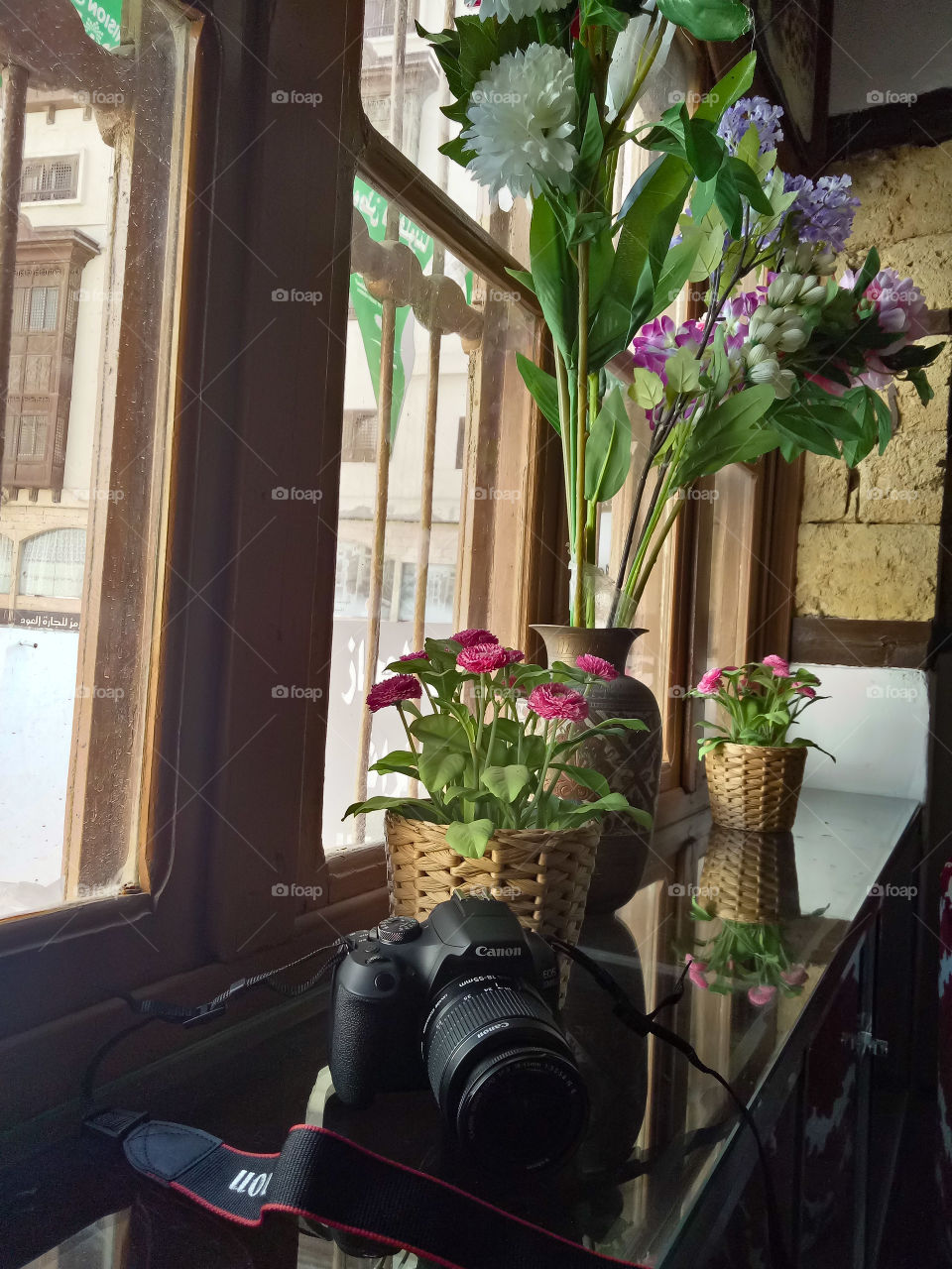 A small cafe with windows adorned with beautiful flowers, a perfect place to stay and relax for a while