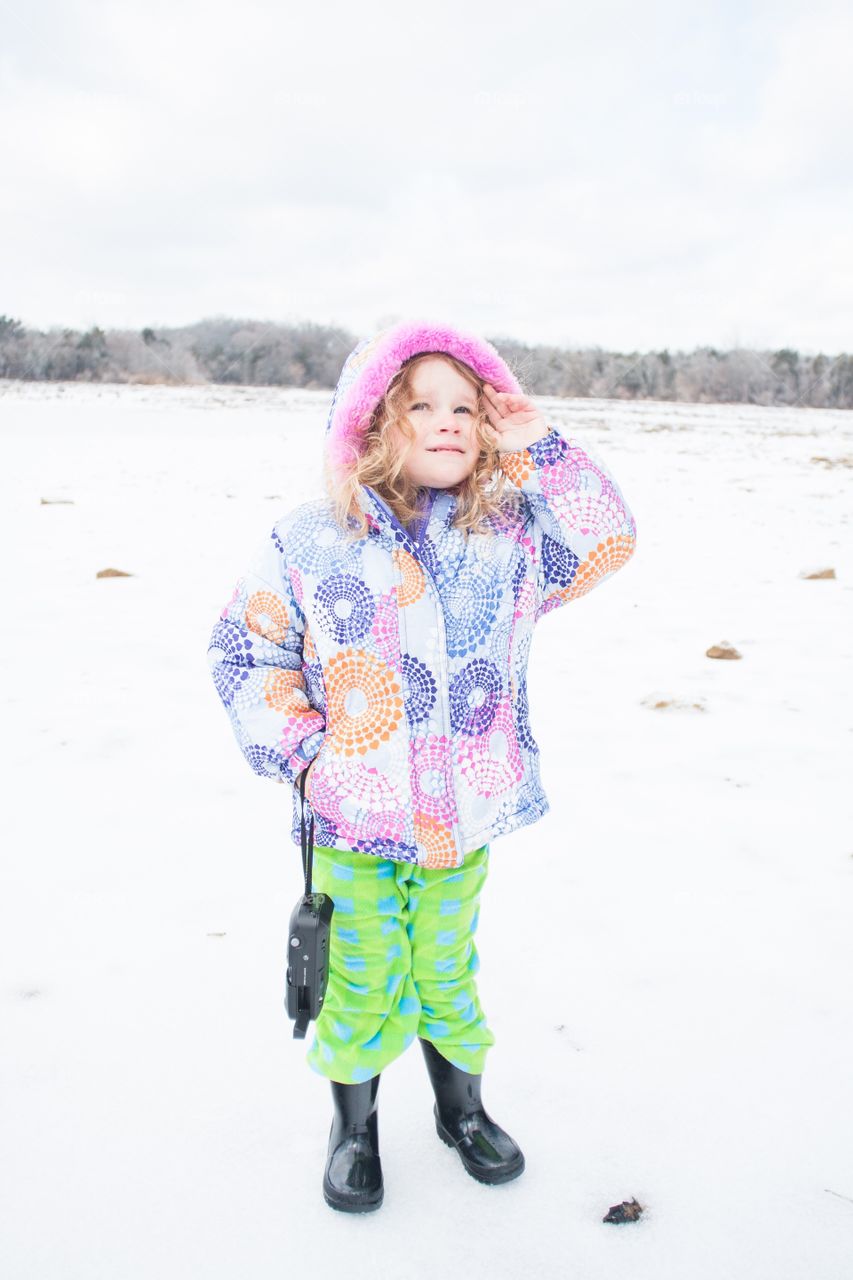 Girl looking up in snow