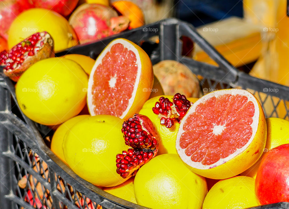 closeup of sliced freh fruit, grapefruit and pomegrante