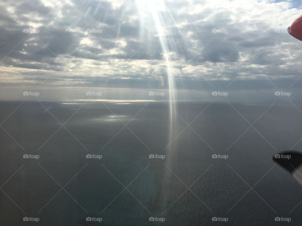 The suns rays forming a glimpse of an angel in the sky. 