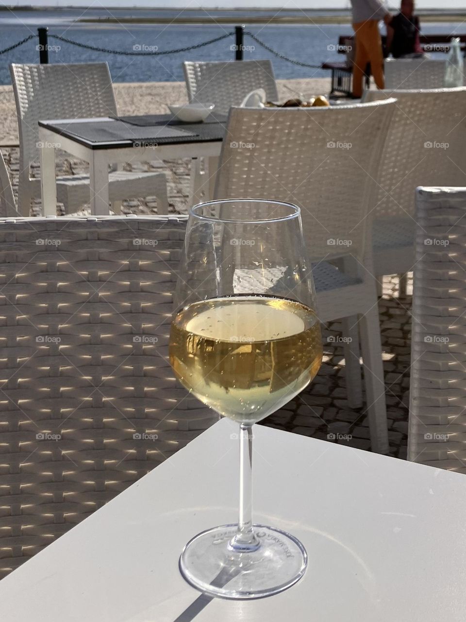 Enjoying a white wine glass by the sea