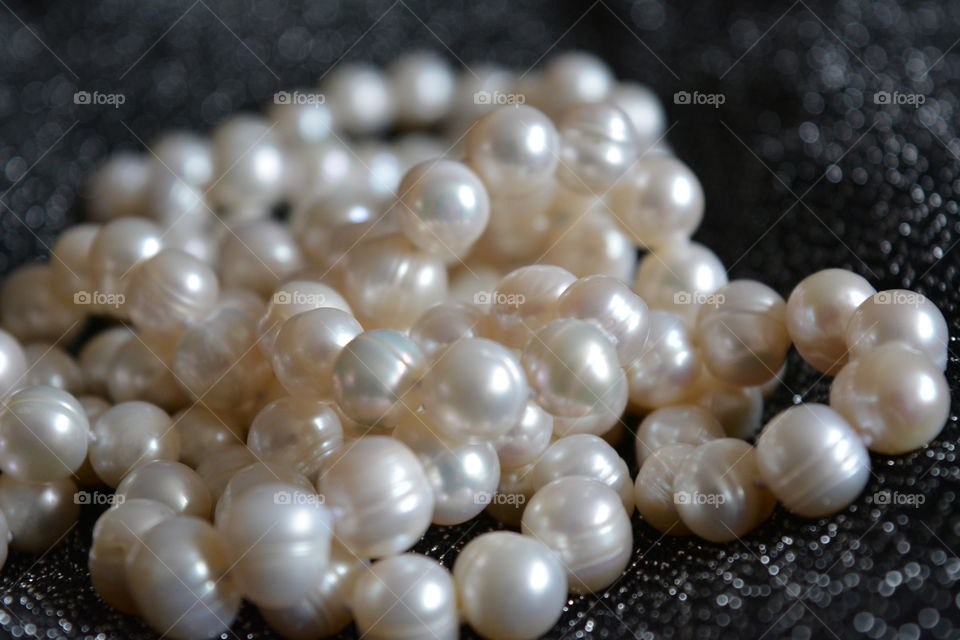 Shiny white pearl on black cloth