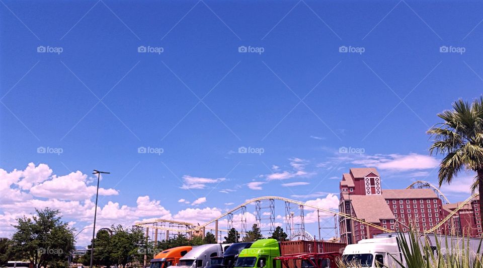 colorful big rigs and a roller coaster at state line