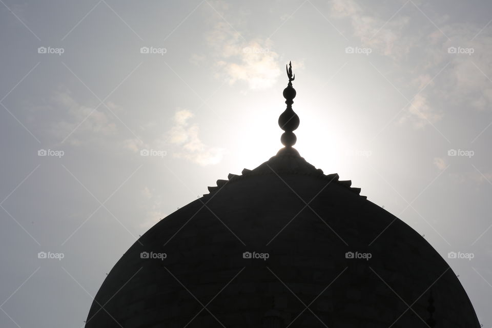 The top of the Taj Mahal as the sun goes down.