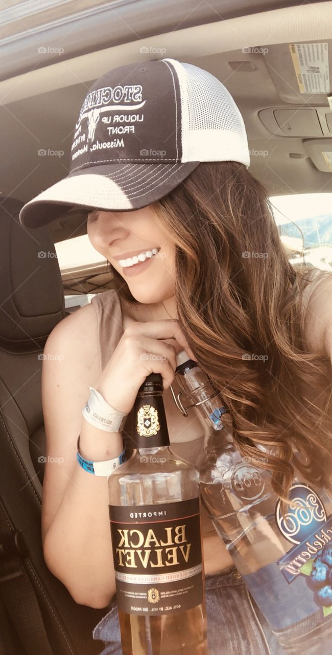 Selfie of a girl at a music festival getting ready to have some fun drinking with friends. 