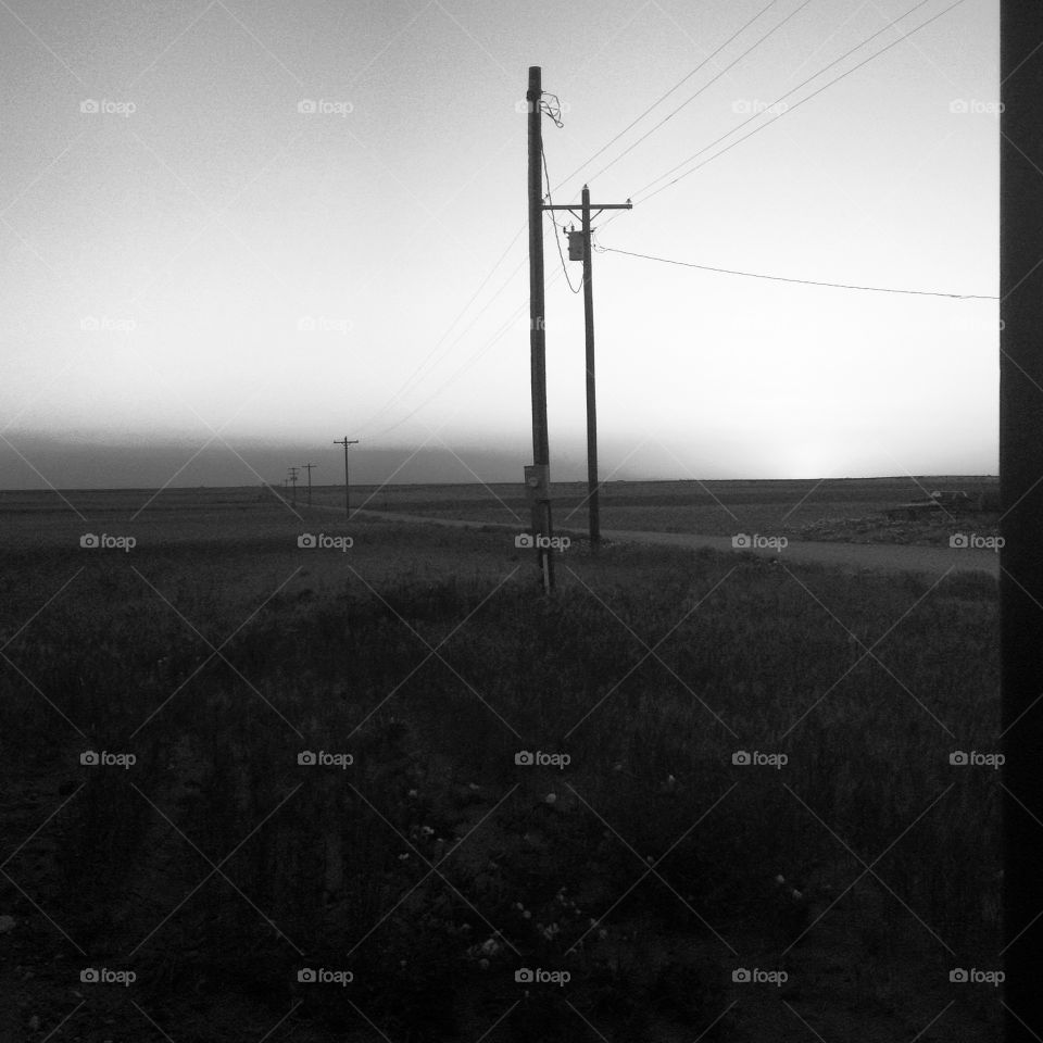 black and white powerlines silhouetted against a West Texas sunset.