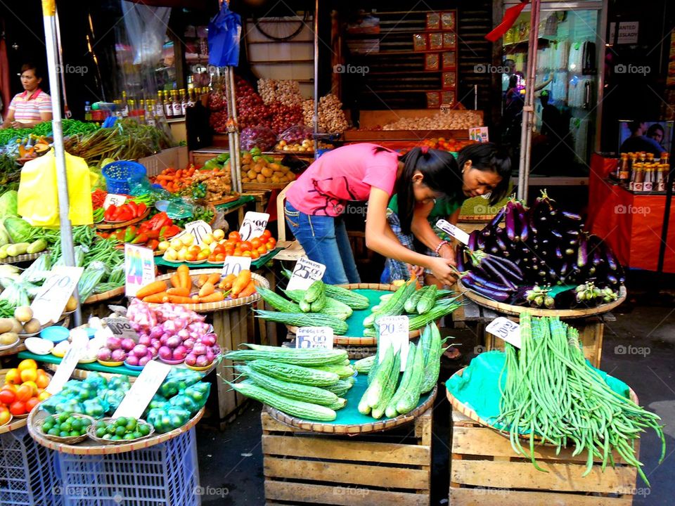 asian street vendor selling fruits and vegetables in quiapo, manila, philippines in asia