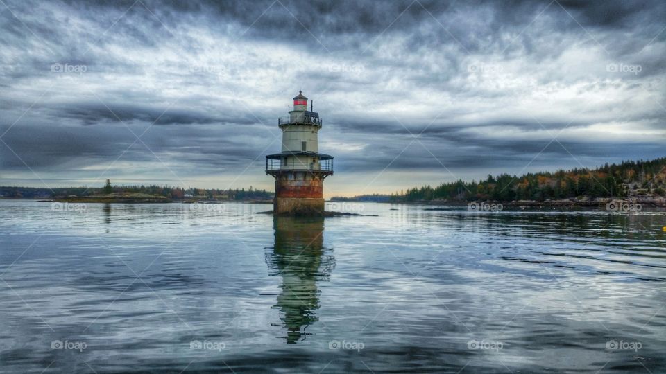 Lighthouse reflecting in lake
