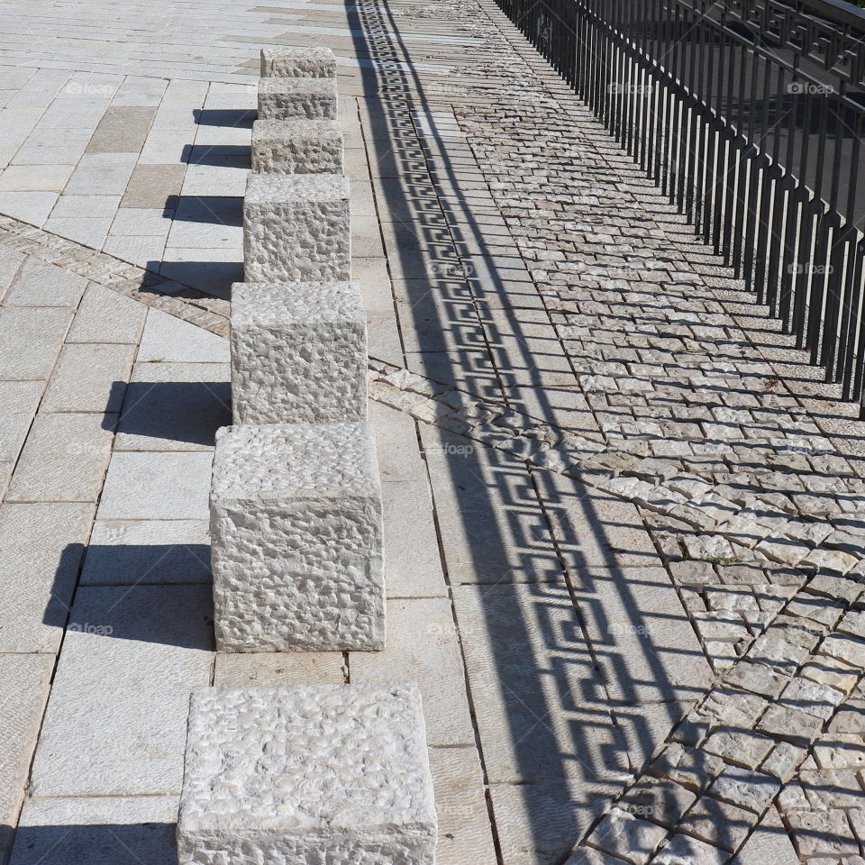 Square stones and square shade with a fence shade 