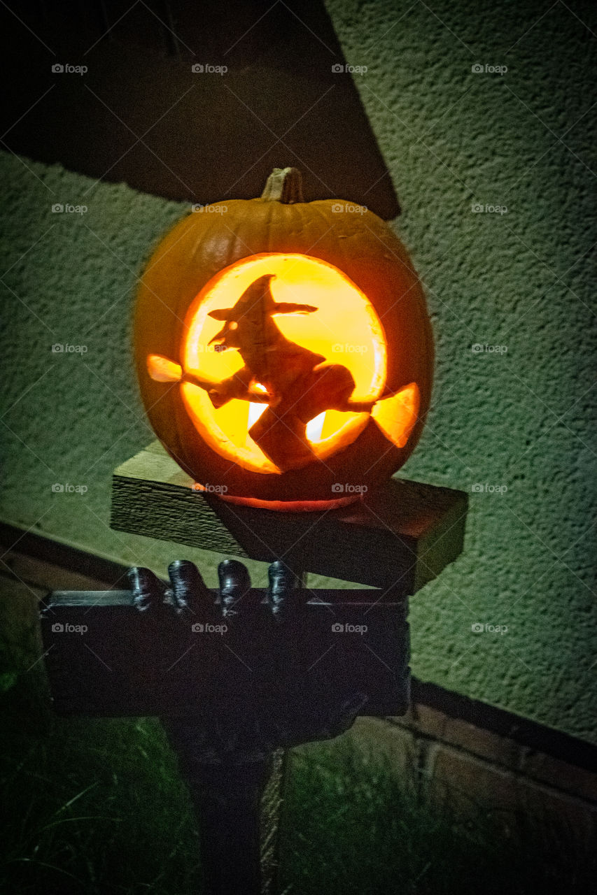 Halloween Pumpkin carved with a witch flying a broomstick